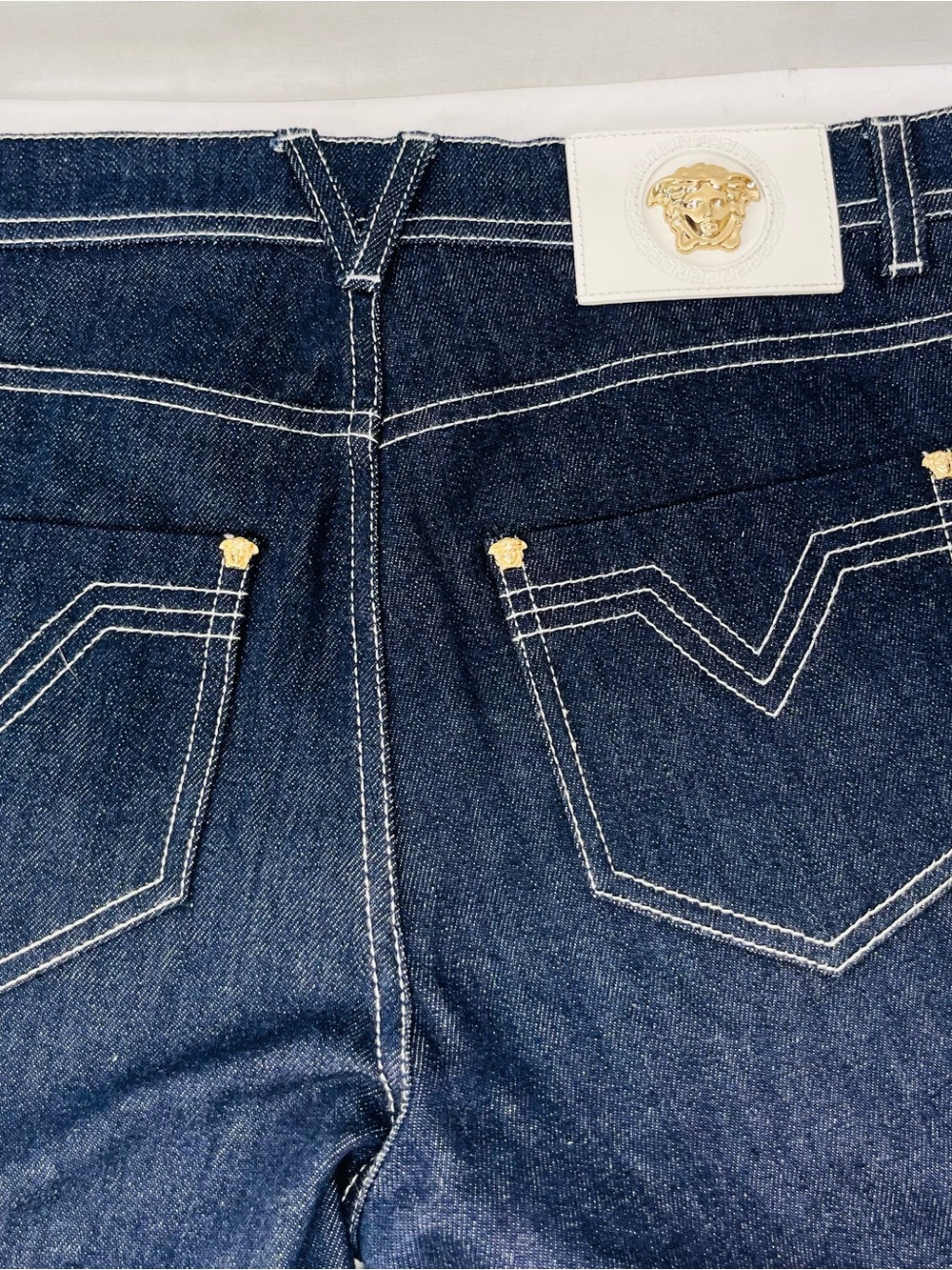 Versace Dark Indigo High-Rise Boot Cut
Jeans with Gold Medusa Accents